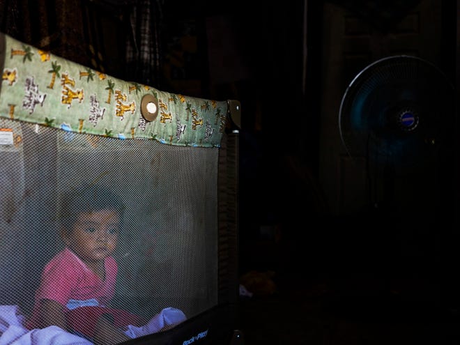 Argian Lopez sits in a crib while his mother sews in their rental apartment in Nogales, Sonora. The mother and son from Guatemala have been stranded under the Migrant Protection Protocols.