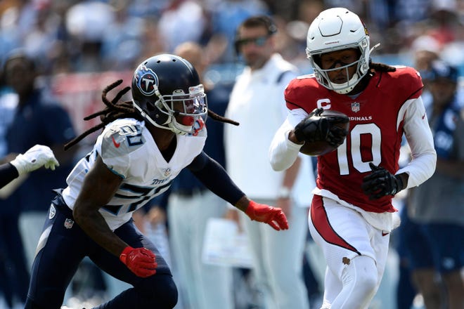 Arizona Cardinals wide receiver DeAndre Hopkins (10) gets a first down while being chased by Tennessee Titans cornerback Janoris Jenkins (20) during the first quarter at Nissan Stadium Sunday, Sept. 12, 2021, in Nashville, Tenn.