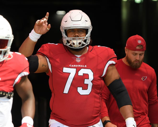 Sep 12, 2021; Nashville, Tennessee, USA;  Arizona Cardinals offensive guard Max Garcia (73) points to the sky as he takes the field against the Tennessee Titansbefore the game at Nissan Stadium. Mandatory Credit: Steve Roberts-USA TODAY Sports