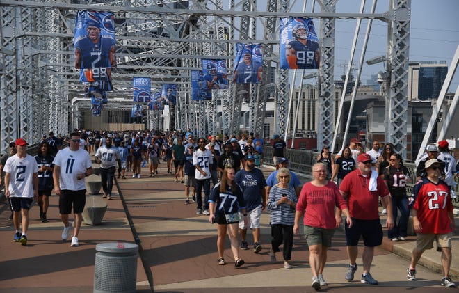 Sep 12, 2021; Nashville, Tennessee, USA; Fans cross the bridge on the way to Nissan Stadium prior to the game between the Tennessee Titans and the Arizona Cardinals. Mandatory Credit: Christopher Hanewinckel-USA TODAY Sports
