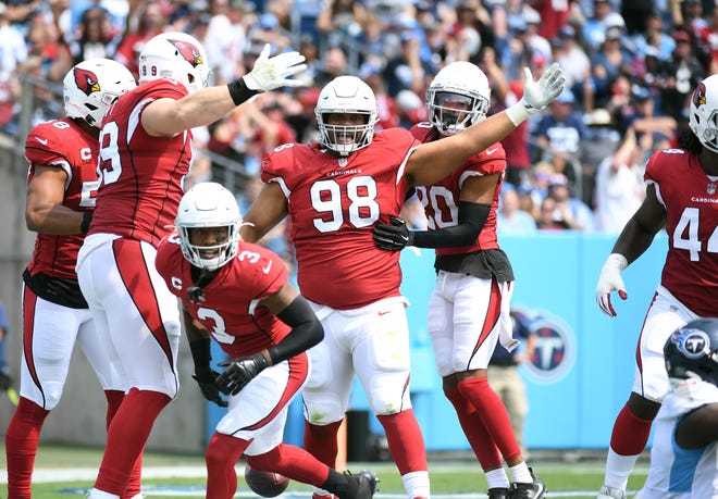 Sep 12, 2021; Nashville, Tennessee, USA; Arizona Cardinals players celebrate after a sack fumble during the first half against the Tennessee Titans at Nissan Stadium. Mandatory Credit: Christopher Hanewinckel-USA TODAY Sports