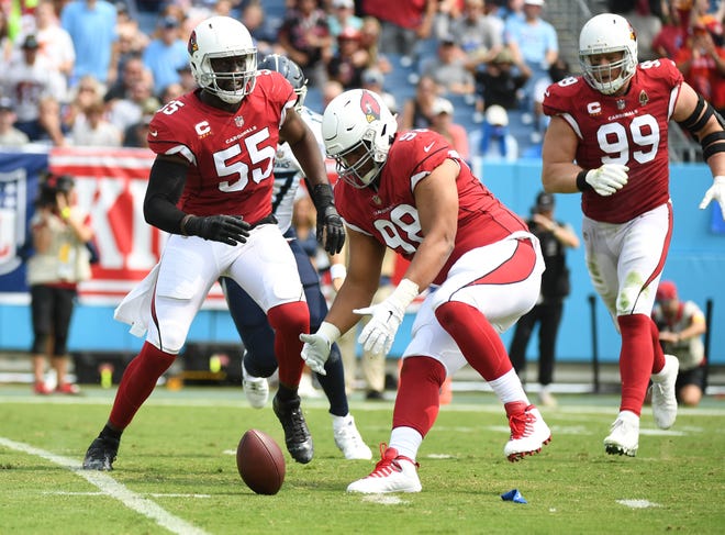 Sep 12, 2021; Nashville, Tennessee, USA; Arizona Cardinals defensive tackle Corey Peters (98) recovers a fumble after a sack fumble forced by Arizona Cardinals defensive end Chandler Jones (55) during the first half against the Tennessee Titans at Nissan Stadium. Mandatory Credit: Christopher Hanewinckel-USA TODAY Sports