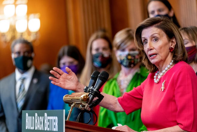 House Speaker Nancy Pelosi, D-Calif., accompanied by other House Democrats and climate activists, pauses while speaking about their "Build Back Better on Climate" plan on Capitol Hill in Washington on Sept. 28, 2021.