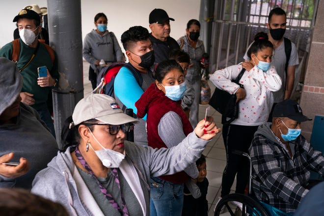 Nancy (centro) y Leo (centro izquierda) esperan con sus dos hijos, Alexander, de 3 años, y Gael, de 1, para hablar con un oficial de la Patrulla Fronteriza mientras solicitan asilo en el Puerto de Entrada de Aduanas y Protección Fronteriza de los EE. UU.-Dennis DeConcini en noviembre 8, 2021, en Nogales, México.