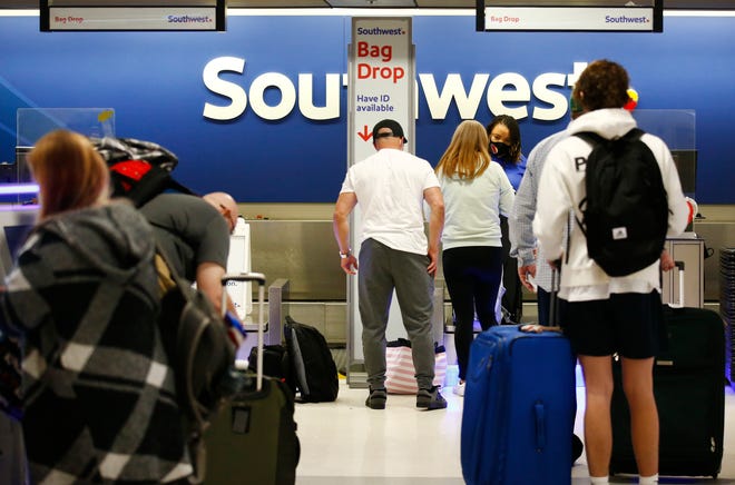 Lines begin to form at the Southwest ticketing area inside Terminal 4 at Phoenix Sky Harbor International Airport on Nov. 23, 2021, in Phoenix.
