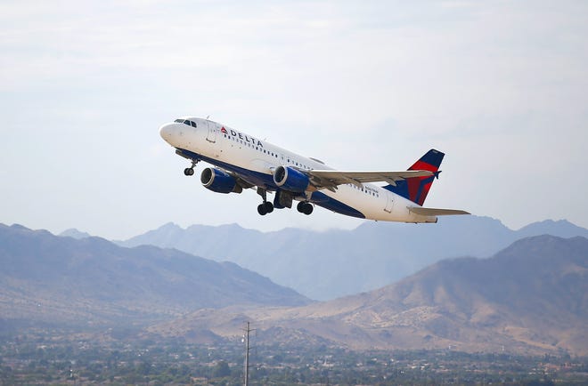 A Delta plane makes its way from Phoenix Sky Harbor International Airport on the Wednesday before Thanksgiving on Nov. 23, 2021, in Phoenix.