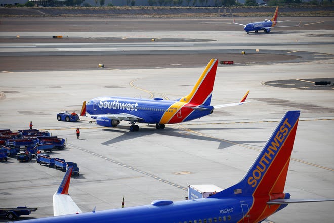 A Southwest plane taxis away from its gate at Phoenix Sky Harbor International Airport on the Wednesday before Thanksgiving on Nov. 24, 2021, in Phoenix.