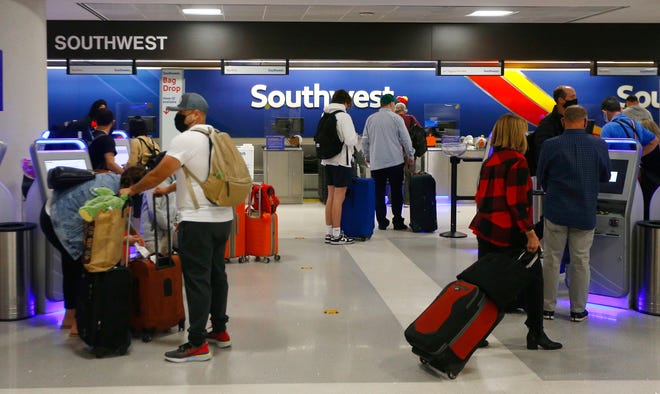 Lines begin to stack up as Thanksgiving travelers make their way to their ticketing agents at Phoenix Sky Harbor International Airport on Nov. 23, 2021, in Phoenix.
