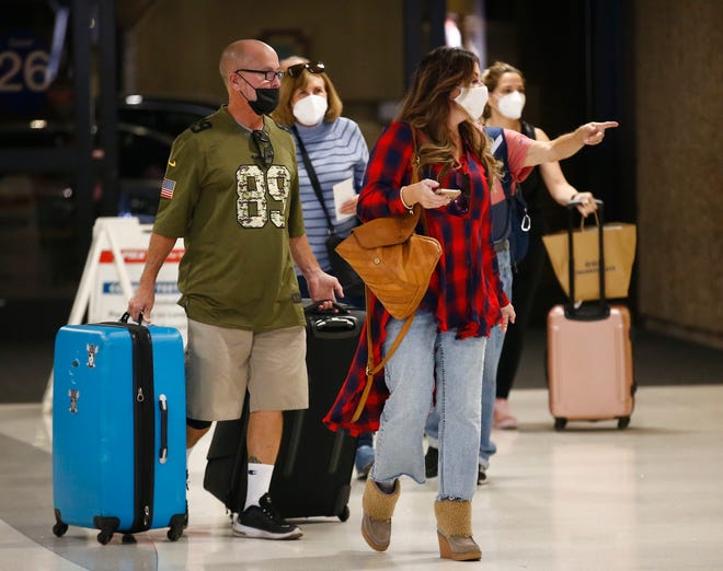 Travelers check in for tickets before departing to their gates on the Wednesday before Thanksgiving at Phoenix Sky Harbor International Airport on Nov. 23, 2021, in Phoenix.