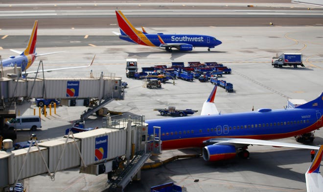 A Southwest plane taxis away from its gate at Phoenix Sky Harbor International Airport on the Wednesday before Thanksgiving on Nov. 23, 2021, in Phoenix.