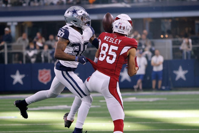 Dallas Cowboys cornerback Anthony Brown (30) breaks up a pass intended for Arizona Cardinals wide receiver Antoine Wesley (85) during the first half of an NFL football game Sunday, Jan. 2, 2022, in Arlington, Texas.