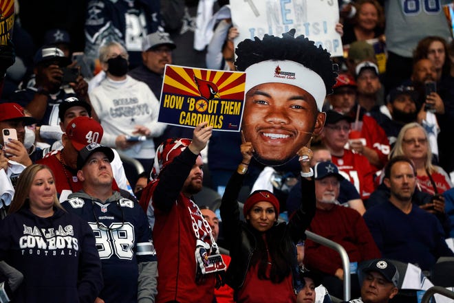 Arizona Cardinals fans cheer during the first half of an NFL football game against the Dallas Cowboys Sunday, Jan. 2, 2022, in Arlington, Texas. (AP Photo/Michael Ainsworth)