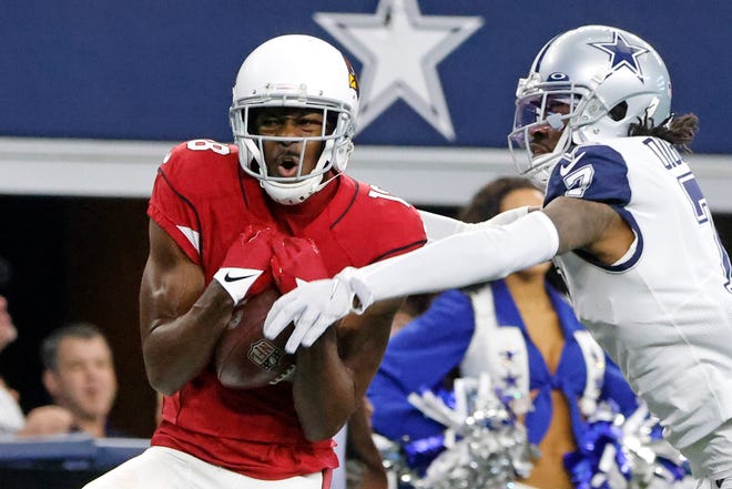 Arizona Cardinals wide receiver A.J. Green, left, catches a pass for a first down as Dallas Cowboys cornerback Trevon Diggs (7) defends during the first half of an NFL football game Sunday, Jan. 2, 2022, in Arlington, Texas.