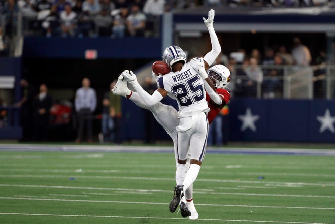 Dallas Cowboys cornerback Nahshon Wright (25) hits Arizona Cardinals running back Jonathan Ward (29) as he reaches to catch a pass during the first half of an NFL football game Sunday, Jan. 2, 2022, in Arlington, Texas. Wright was called for pass interference. (AP Photo/Roger Steinman)