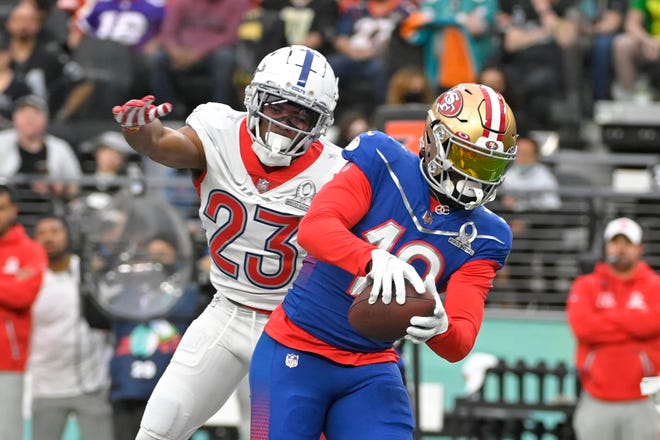 NFC wide receiver Deebo Samuel of the San Francisco 49ers (19) makes a catch in front of AFC cornerback Kenny Moore of the Indianapolis Colts (23) during the first half of the Pro Bowl NFL football game, Sunday, Feb. 6, 2022, in Las Vegas.