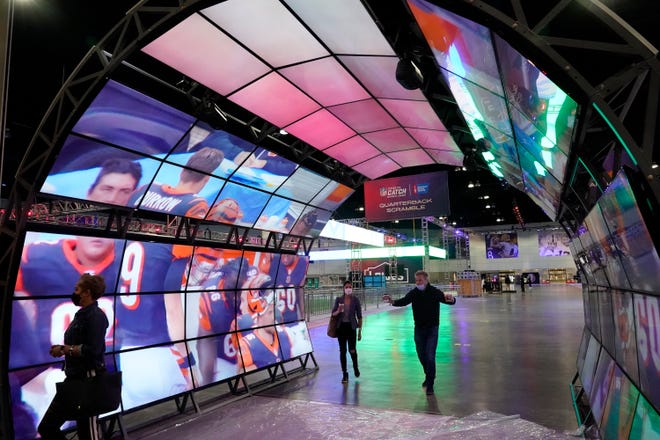 Members of the news media take part in a tour inside the NFL Experience, an interactive fan show, at the Los Angeles Convention Center in Los Angeles. The Los Angeles Rams play the Cincinnati Bengals in the Super Bowl on Sunday in Inglewood.