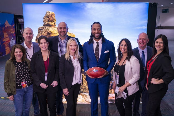 Members of the Arizona Super Bowl host committee pose for a photo after the official Super Bowl Host Committee hand off press conference at the Los Angeles Convention Center on Monday, Feb. 14, 2022, in Los Angeles.