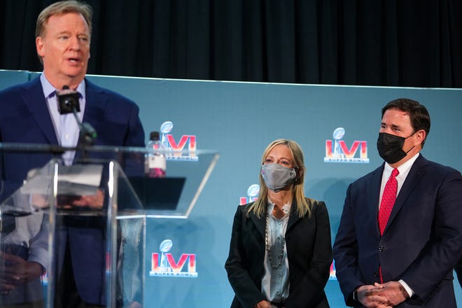Jay Parry, Arizona Super Bowl Host Committee CEO (center), and Doug Ducey, Arizona governor (right), listen to Roger Goodell, Commissioner of the NFL, speak during the official Super Bowl Host Committee handoff press conference at the Los Angeles Convention Center on Monday, Feb. 14, 2022, in Los Angeles.