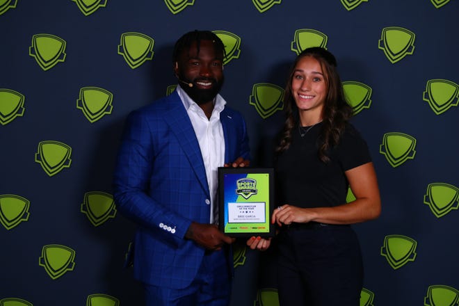 Bree Garcia, Barry Goldwater, is greeted by Cardinals running back Eno Benjamin backstage during the 2022 Arizona High School Sports Awards at ASU Gammage Theater.