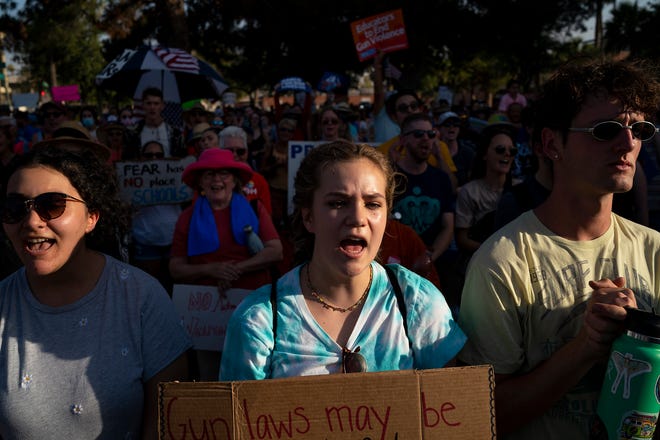 Amber Kassisieh (left) Stormy Light (middle) and Zac Whaley (right) yell in support as Rep. Jennifer Longdon asks the crowd "Are you angry?" during the annual March for Our Lives protest, a nationwide demonstration in support of gun control legislation, at the Arizona State Capitol on Saturday, June 11, 2022.