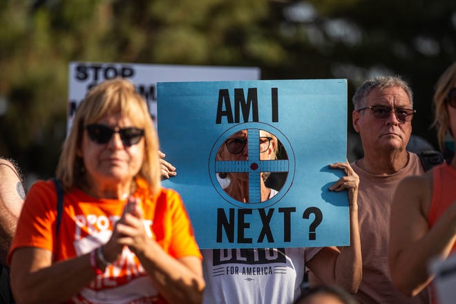 A woman holds a sign to protest recent mass shooting in the country as hundreds of people gather outside the Arizona Capitol on June 11, 2022, in Phoenix as part of a nationwide demonstration calling for stricter gun laws.
