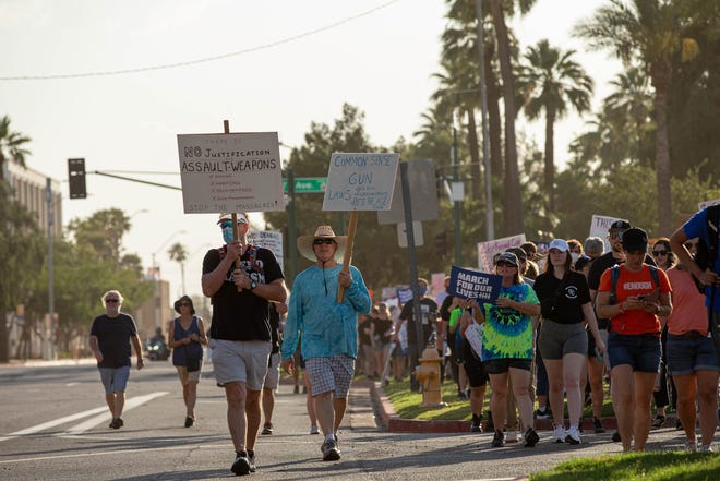 Hundreds of people marched outside the Arizona Capitol on June 11, 2022, in Phoenix as part of a nationwide demonstration calling for stricter gun laws in response to recent mass shootings.