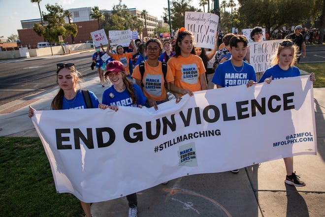 Students hold a banner calling for an end to gun violence as they lead hundreds of people in a march outside the Arizona Capitol on June 11, 2022, in Phoenix as part of a nationwide demonstration for stricter gun laws in response to recent mass shootings.
