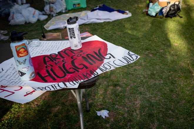 A sign rests on a table outside the Arizona Capitol on June 11, 2022, in Phoenix. Hundreds of people took part in a nationwide demonstration calling for stricter gun laws in response to recent mass shootings.