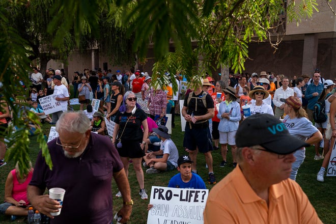 People wait for speakers to take the stage during the annual March for Our Lives protest, a nationwide demonstration in support of gun control legislation, at the Arizona State Capitol on Saturday, June 11, 2022. The event brought out nearly a thousand people.