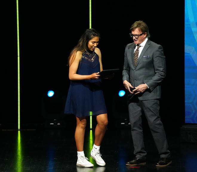 Gracelyn Nez, Flagstaff, accepts her award for Girls Athlete of the Yearfrom Republic sports writer Richard Obert during the 2022 Arizona High School Sports Awards show.