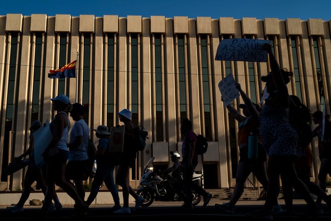 Protesters march down West Jefferson Street during the annual March for Our Lives protest, a nationwide demonstration in support of gun control legislation, at the Arizona State Capitol on Saturday, June 11, 2022.