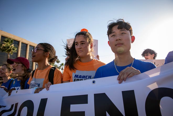 Students hold a banner calling for an end to gun violence as they lead hundreds of people in a march outside the Arizona Capitol on June 11, 2022, in Phoenix as part of a nationwide demonstration for stricter gun laws in response to recent mass shootings.