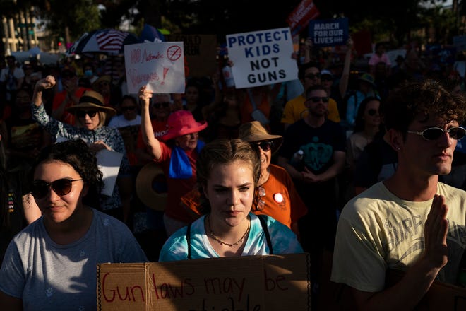 Amber Kassisieh (left) Stormy Light (middle) and Zac Whaley (right) listen to speakers before marching during the annual March for Our Lives protest, a nationwide demonstration in support of gun control legislation, at the Arizona State Capitol on Saturday, June 11, 2022.