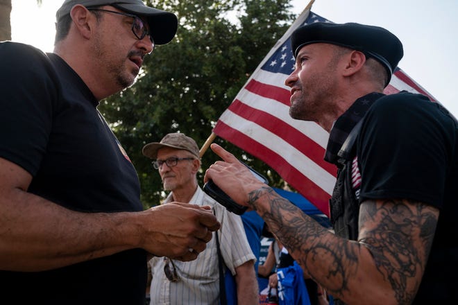 Adrian Fontes, candidate for Arizona Secretary of State, left, argues with a counter-protester during the annual March for Our Lives protest, a nationwide demonstration in support of gun control legislation, at the Arizona State Capitol on Saturday, June 11, 2022.