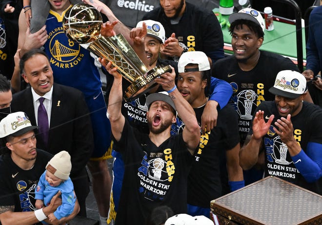 Game 6: Steph Curry raises the Larry O'Brien Trophy after the Warriors defeated the Celtics to clinch the title.