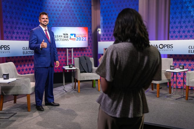 Scott Neely poses for a photo before a debate with Republican candidates ahead of the Aug. 2 primary election for the Arizona governor's office on Wednesday, June 29, 2022, in Phoenix.