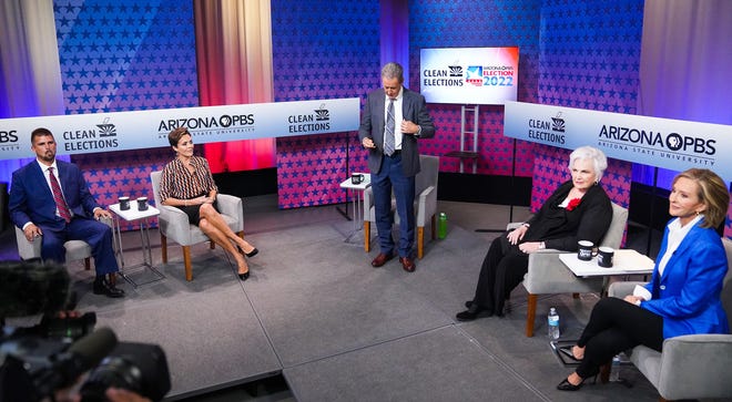 (From left) Scott Neely, Kari Lake, Ted Simons, Paola Tulliani Zen and Karrin Taylor Robson prepare before a debate with Republican candidates ahead of the Aug. 2, 2022, primary election for the Arizona governor's office in Phoenix.