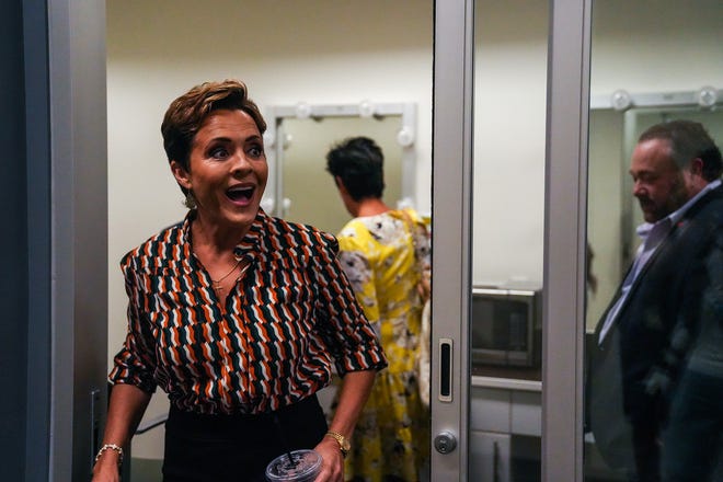 Kari Lake steps out of a dressing room after a debate with Republican candidates ahead of the Aug. 2 primary election for the Arizona governor's office on Wednesday, June 29, 2022, in Phoenix.