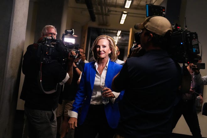 Karrin Taylor Robson walks toward elevators as journalists ask her questions after a debate with Republican candidates ahead of the Aug. 2 primary election for the Arizona governor's office on Wednesday, June 29, 2022, in Phoenix.
