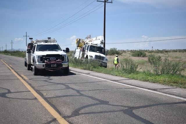 APS workers restringing wire across the road on highway 191 and Leake Road in Douglas after a storm caused major power outages.