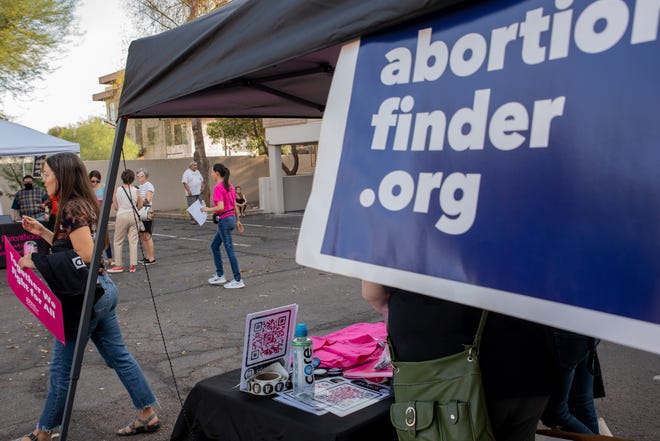 Volunteers hand out signs as a show of support for abortion rights at a storytelling event organized by the local chapter of Planned Parenthood in Phoenix on July 25, 2022.