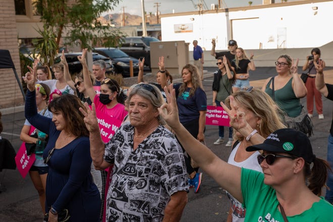 Attendees raised their fingers to count the number of available actions to support abortion rights at a storytelling event organized by the local chapter of Planned Parenthood in Phoenix on July 25, 2022.
