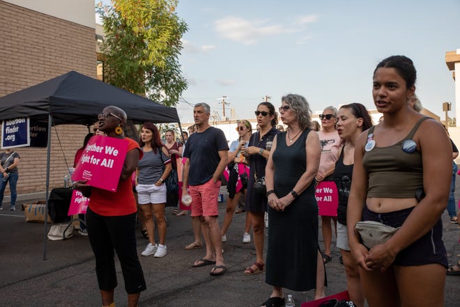 Attendees at a storytelling event organized by the local chapter of Planned Parenthood listen to one of the speakers' abortion story outside the organization's office in Phoenix on July 25, 2022.