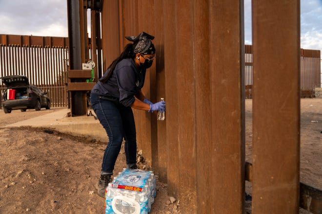 Nathalie Hernandez Barahona, volunteer coordinator of the AZ-CA Humanitarian Coalition, places water for migrants and asylum seekers at the U.S.-Mexico border in San Luis, Arizona, on July 28, 2022.