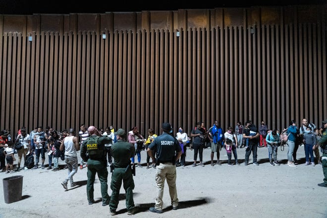 Migrants and asylum seekers are detained by U.S. Border Patrol agents after crossing the U.S.-Mexico border in Yuma County, Ariz., near the Cocopah tribe’s reservation on July 28, 2022.