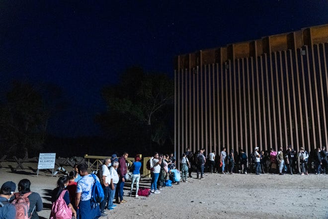 Migrants and asylum seekers are detained by U.S. Border Patrol agents after crossing the U.S.-Mexico border in Yuma County, Arizona, near the Cocopah Indian Tribe’s reservation on July 28, 2022.