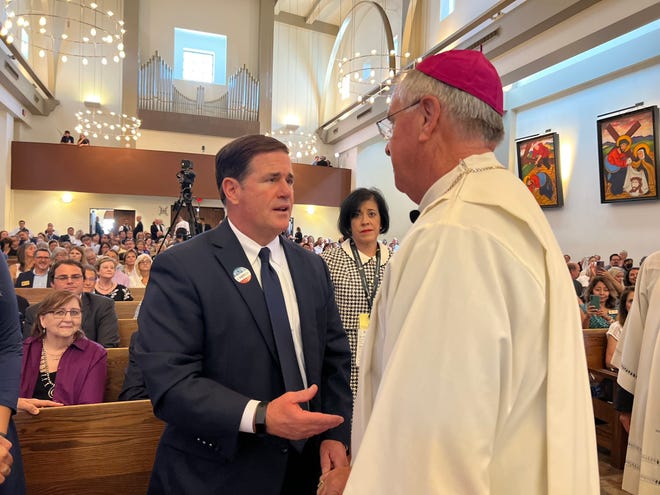 Arizona Gov. Doug Ducey talks with Bishop John Dolan as he is installed as the fifth Bishop of the Phoenix Diocese on Aug. 2, 2022.