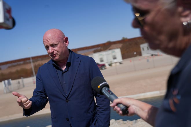 U.S. Sen. Mark Kelly speaks to the media about the barrier gaps at Morelos Dam on Aug. 10, 2022, in Yuma.