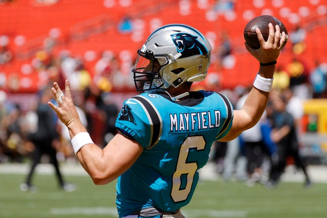 Carolina Panthers quarterback Baker Mayfield passes the ball during warmups prior to the preseason game against the Washington Commanders at FedExField.