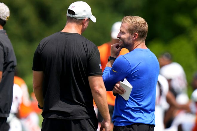 Cincinnati Bengals head coach Zac Taylor, left, and Los Angeles Rams head coach Sean McVay, right, talk during a joint practice, Wednesday, Aug. 24, 2022, at the Paycor Stadium practice fields in Cincinnati.